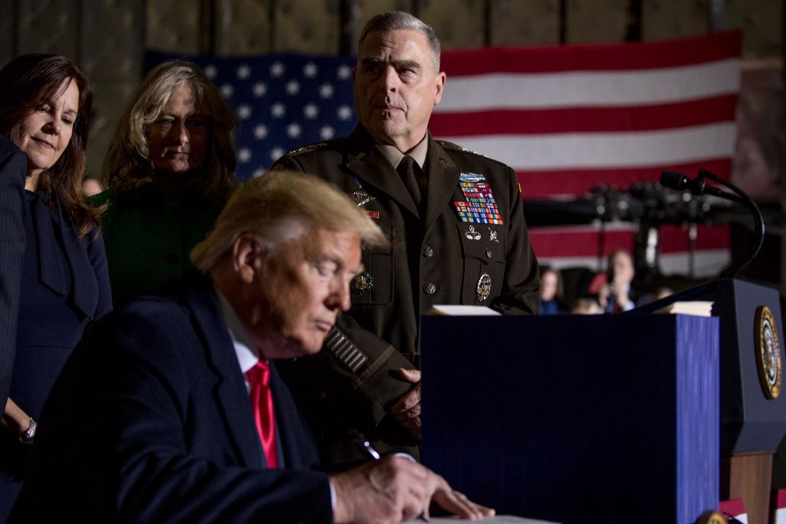 Joint Chiefs Chairman Gen. Mark Milley, top center, watches as President Donald Trump signs the National Defense Authorization Act for Fiscal Year 2020 at Andrews Air Force Base, Maryland, December 2019.