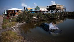 Homes destroyed in the wake of Hurricane Ida are shown in addition to a submerged automobile September 2, 2021 in Grand Isle, Louisiana. Ida made landfall August 29 as a Category 4 storm near Grand Isle, southwest of New Orleans, causing widespread power outages, flooding and massive damage. 