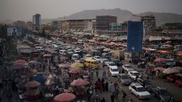 Cars wait in traffic as Afghans shop in a local market in Kabul, Afghanistan, Saturday, Sept. 11, 2021. 
