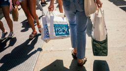 Pedestrians carry shopping bags in the SoHo neighborhood of New York, U.S., on Wednesday, Aug. 25, 2021. Consumer spending in the second quarter grew 11.9%. 