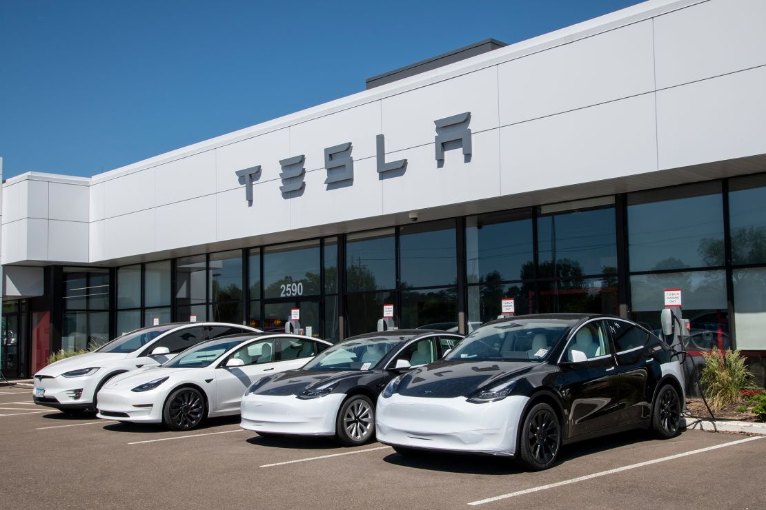 Cars at charging stations at a Tesla car dealership in Maplewood, Minnesota on June 13, 2021.