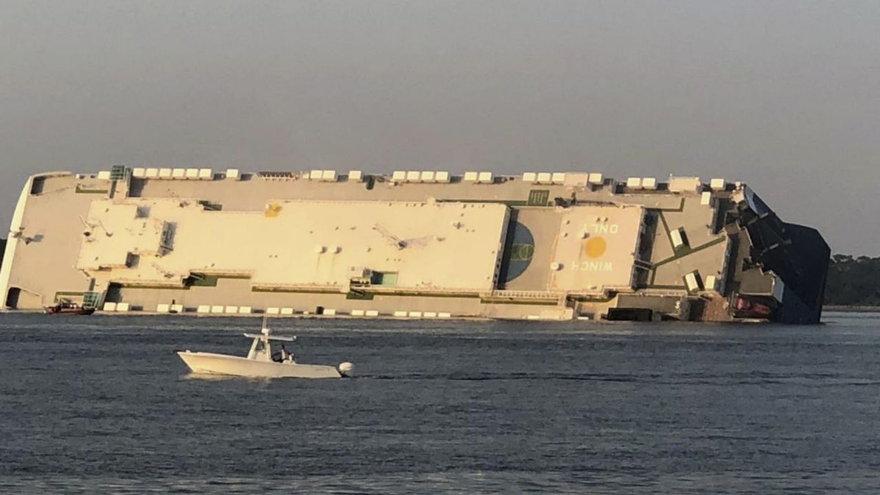 The Golden Ray cargo ship is capsized near a port on the Georgia coast, Sunday, Sept. 8, 2019. Rescuers were searching Sunday for multiple crew members of the ship that overturned and caught fire in St. Simons Sound, Ga. (Buff Leavy/The Brunswick News via AP)