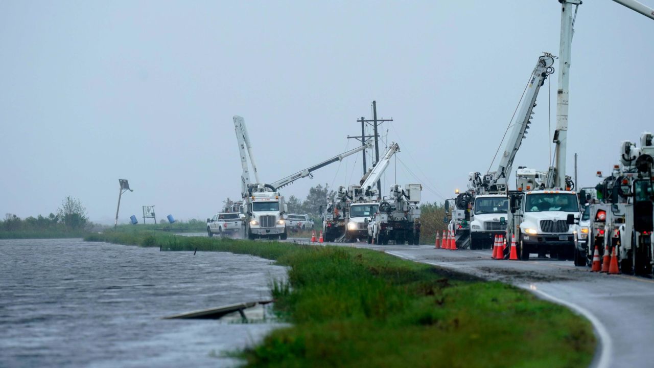 Utility crews on Tuesday replace power poles destroyed by Hurricane Ida in Pointe-aux-Chenes, Louisiana.