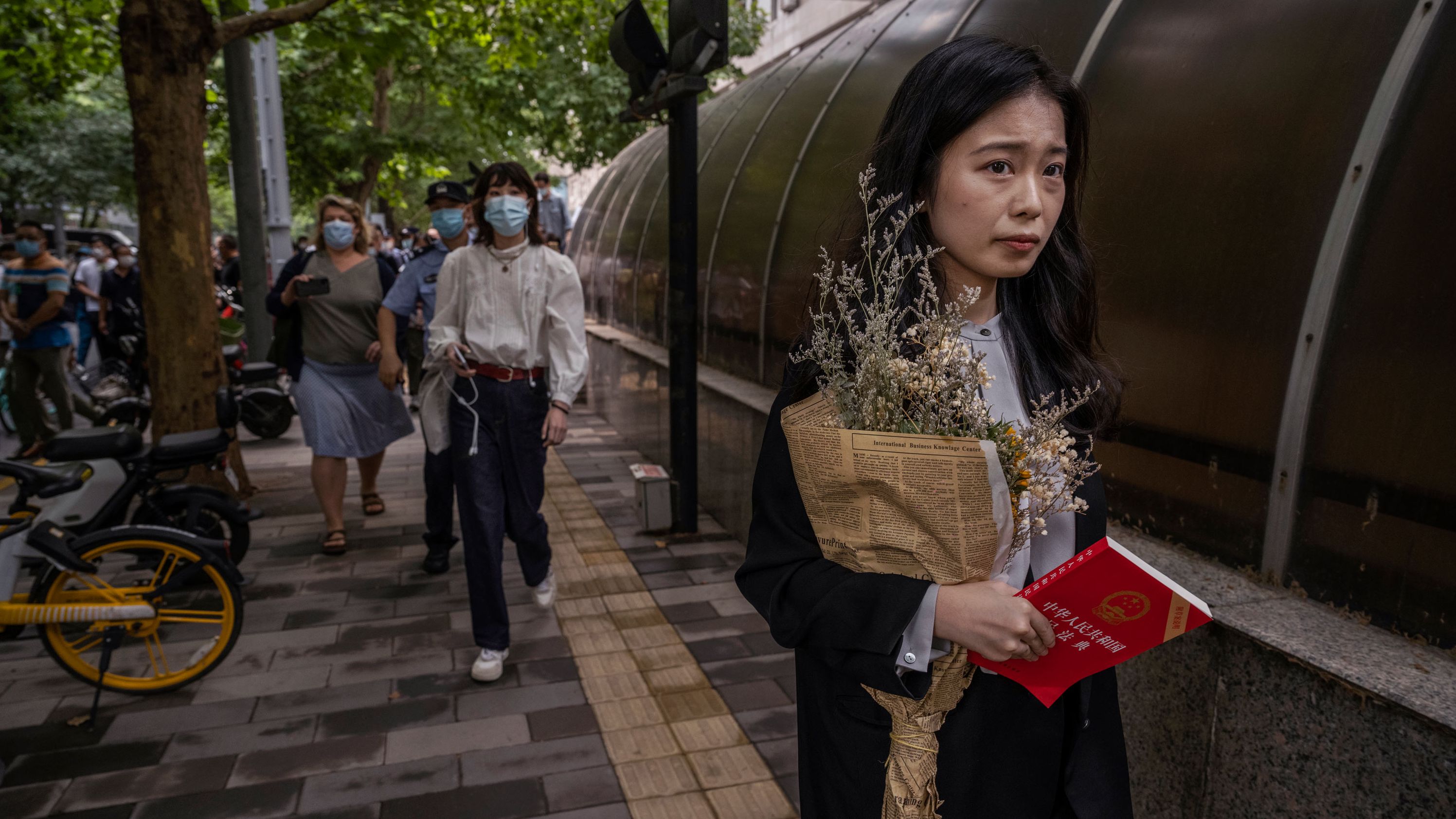 Zhou Xiaoxuan, a leading figure in China's #MeToo movement, arrives at the Haidian District People's Court before a hearing in her case against prominent television host Zhu Jun on September 14 in Beijing, China. 