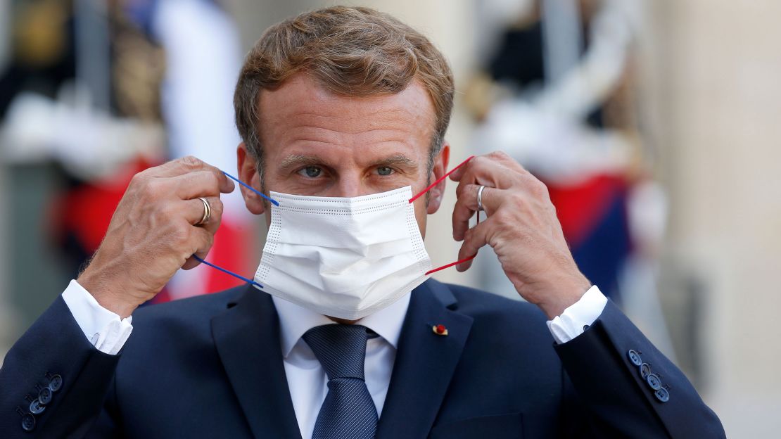 French President Emmanuel Macron adjusts his face mask at the Elysee Presidential Palace on September 6 in Paris, France.