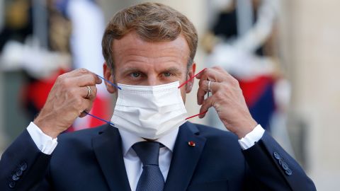 French President Emmanuel Macron adjusts his face mask at the Elysee Presidential Palace on September 6 in Paris, France.