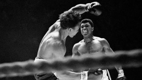 Three-time world heavyweight boxing champion Muhammad Ali is shown in the ring.