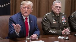 President Donald Trump speaks to members of the media, as Mark Milley, chairman of the joint chiefs of staff, right, listens during a briefing with senior military leaders in Washington, on Oct. 7, 2019. Trump appeared to backpedal after giving Turkey a green light to attack U.S.-allied Kurdish forces in northern Syria, warning Ankara in a tweet that he would "totally destroy and obliterate" the country's economy if it takes unspecified "off limits" actions. 