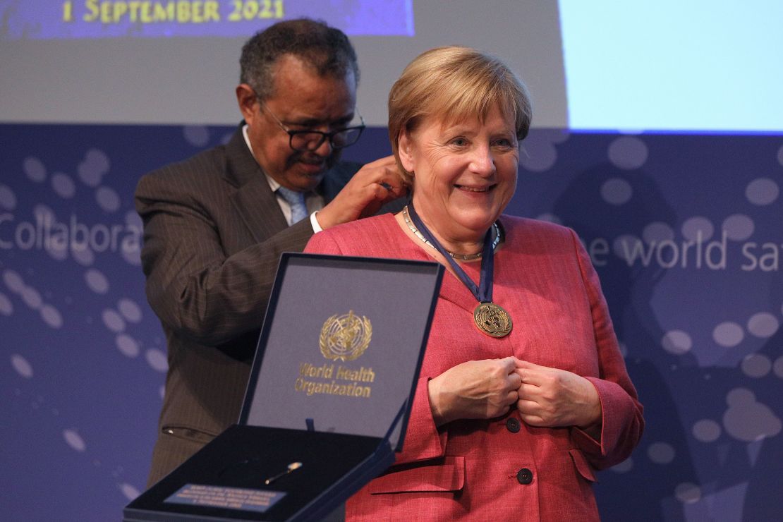 Merkel receives a medal from Tedros Adhanom Ghebreyesus, Director General of the World Health Organization, during the opening of a WHO hub in Berlin on September 1, 2021. 