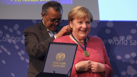 Merkel receives a medal from Tedros Adhanom Ghebreyesus, Director General of the World Health Organization, during the opening of a WHO hub in Berlin on September 1, 2021. 