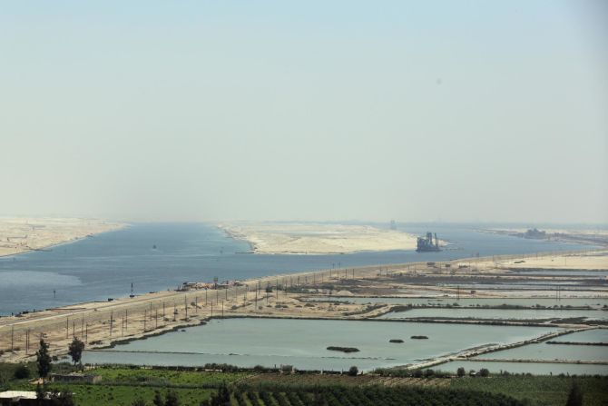 This image shows the two channels of the Suez Canal during the opening ceremony of the expansion in 2015. The new 35-kilometer channel was designed to increase the capacity of ships. Further improvement will be <a href="index.php?page=&url=https%3A%2F%2Fedition.cnn.com%2F2021%2F01%2F14%2Fafrica%2Fgallery%2Fafrica-infrastructure-projects-hnk-spc-intl%2Findex.html" target="_blank">vital</a> for economic growth in the coming decade. 