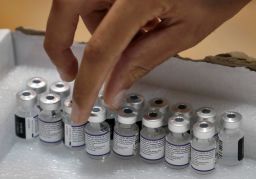 A paramedic with Israel's Magen David Adom medical service gets a vial of the Pfizer-BioNTech Covid-19 vaccine on August 24, 2021 at a vaccination centre in Holon. - Israel lowered the age threshold to receive a third coronavirus booster dose to anyone aged 30 and above, as it continues to battle surging infections. (Photo by AHMAD GHARABLI/AFP via Getty Images)