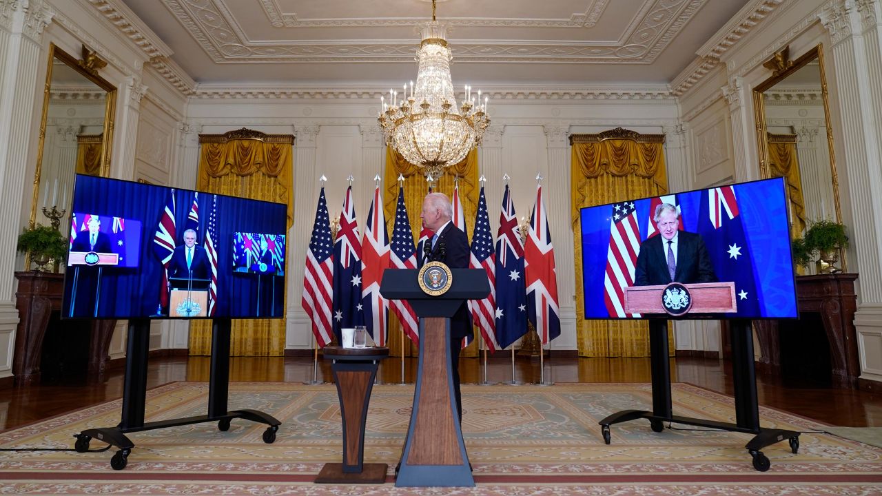 President Joe Biden, listens as he is joined virtually by Australian Prime Minister Scott Morrison, left, and British Prime Minister Boris Johnson, speaks about a national security initiative in the East Room of the White House in Washington, Wednesday, Sept. 15, 2021.