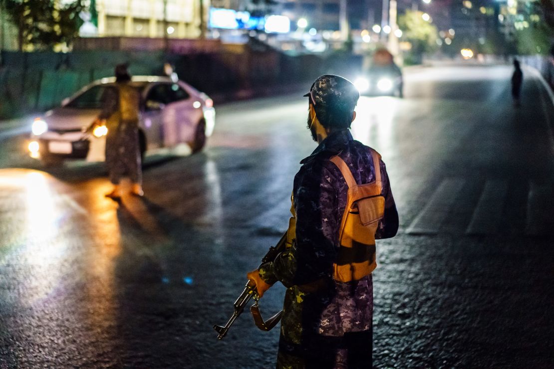 Taliban fighters in new uniforms station themselves at a traffic junction in Kabul on September 5.