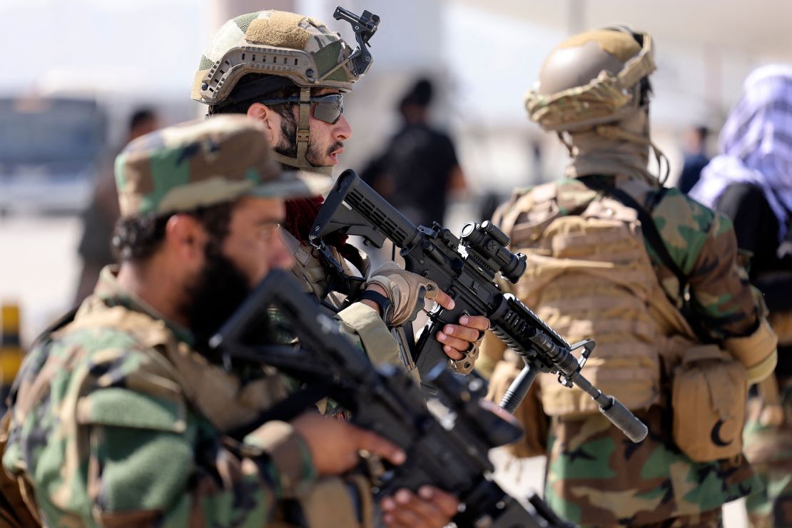 Fighters of the Taliban Badri 313 military unit stand guard at the airport in Kabul on September 14.