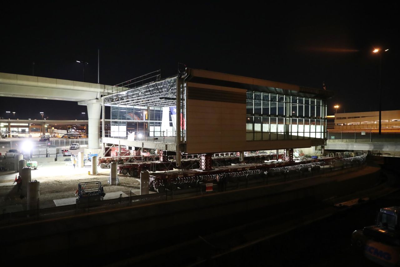 <strong>A big move:</strong> A newly constructed gate, tethered to a high-tech flatbed truck, was moved across the tarmac to be added to Terminal C at Dallas-Fort Worth International Airport.