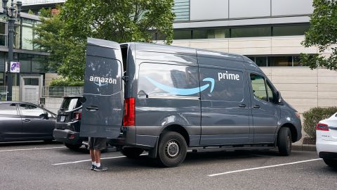 An Amazon worker is seen unloading an Amazon Prime branded van on the roadside in downtown Portland, Oregon in September 2019.