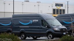 Employees load up Prime delivery vans at the Amazon Fulfillment Center in Portland, Ore., on December 11, 2019. 