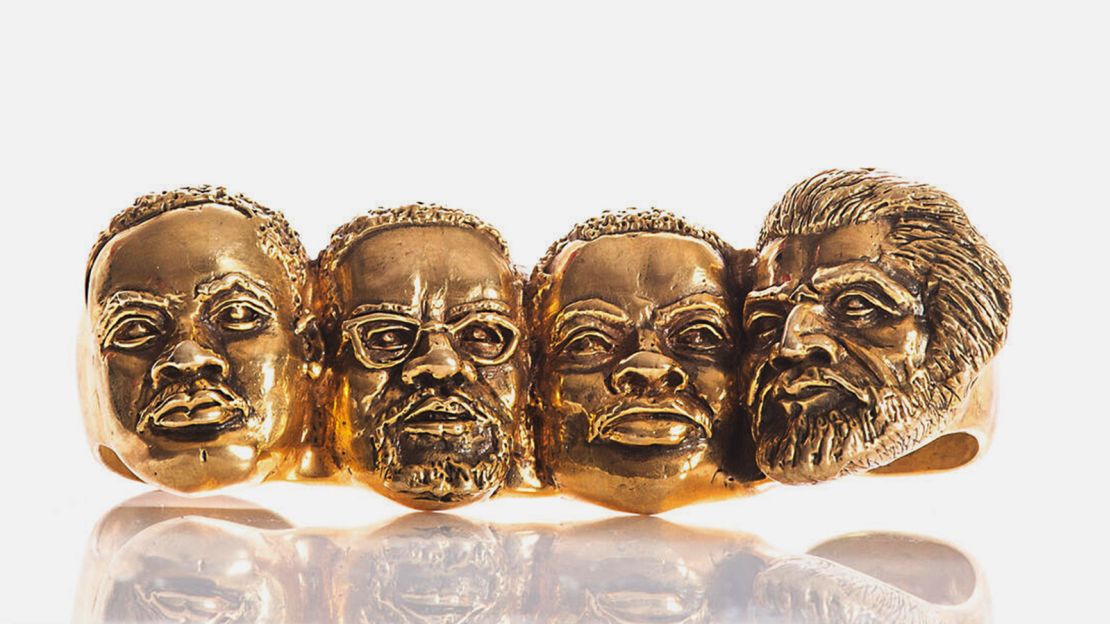 The Let Freedom Ring four-fingered ring by Johnny Nelson, featuring what the designer calls the "civil rights Mount Rushmore." From left to right, likenesses of Martin Luther King Jr., Malcolm X, Marcus Garvey and Frederick Douglass have been hand-carved.