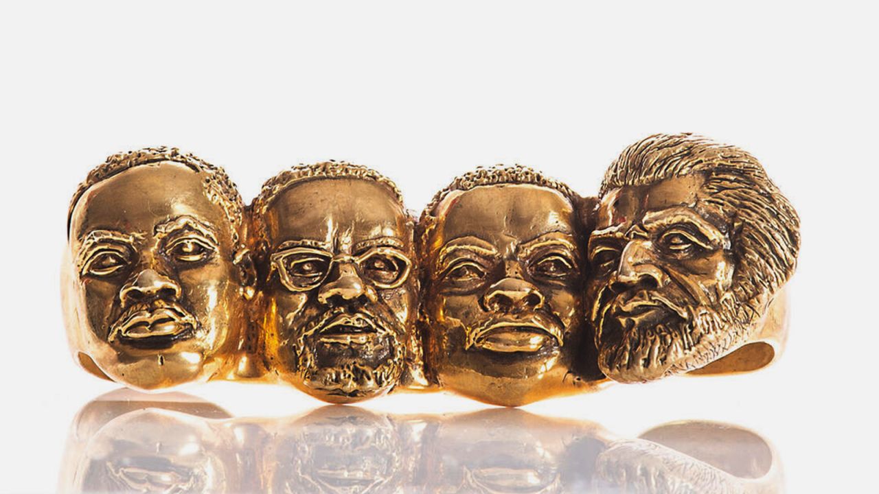 The Let Freedom Ring four-fingered ring by Johnny Nelson, featuring what the designer calls the "civil rights Mount Rushmore." From left to right, likenesses of Martin Luther King Jr., Malcolm X, Marcus Garvey and Frederick Douglass have been hand-carved.