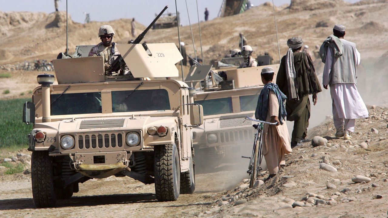 A US Army convoy drives near Lashkar Gah in Afghanistan's southern Helmand province in April 2006. An explosives-packed car detonated near a US base there that month, injuring members of the US military and a team who were training leaders of the Afghan Eradication Force.