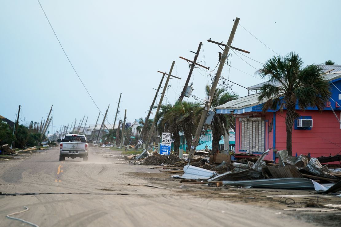 A motorist drives down a road in the wake of Hurricane Ida on September 4, 2021 in Grand Isle, Louisiana.