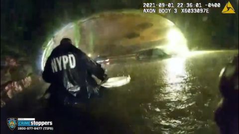Body camera video shows one of the officers walking through the water with a life ring as they rescued the driver.