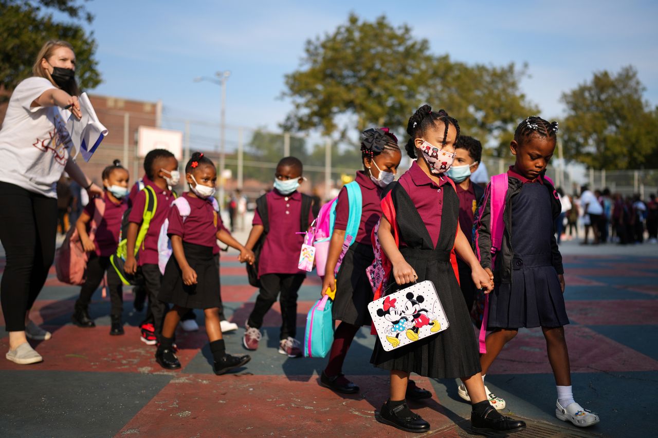 Students arrive for the first day of school at the Mott Hall Bridges Academy in Brooklyn, New York, on Monday, September 13. Students in New York City's public schools —the nation's largest school district — <a href="https://www.cnn.com/2021/09/13/us/new-york-city-back-to-school-covid/index.html" target="_blank">were welcomed back to the classroom Monday</a> for full-time, in-person learning, joining school districts across the country confronting a new academic year amid Covid-19.
