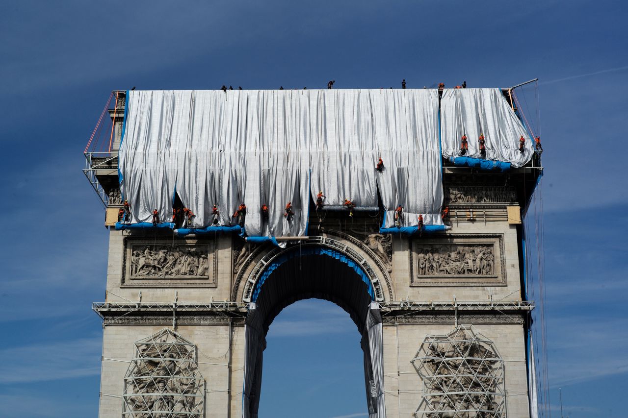 Workers wrap the Arc de Triomphe monument in Paris on Sunday, September 12. The project, by artists Christo and Jeanne-Claude, will include 25,000 square meters of silvery blue fabric. It will be on view from September 18 until October 3.