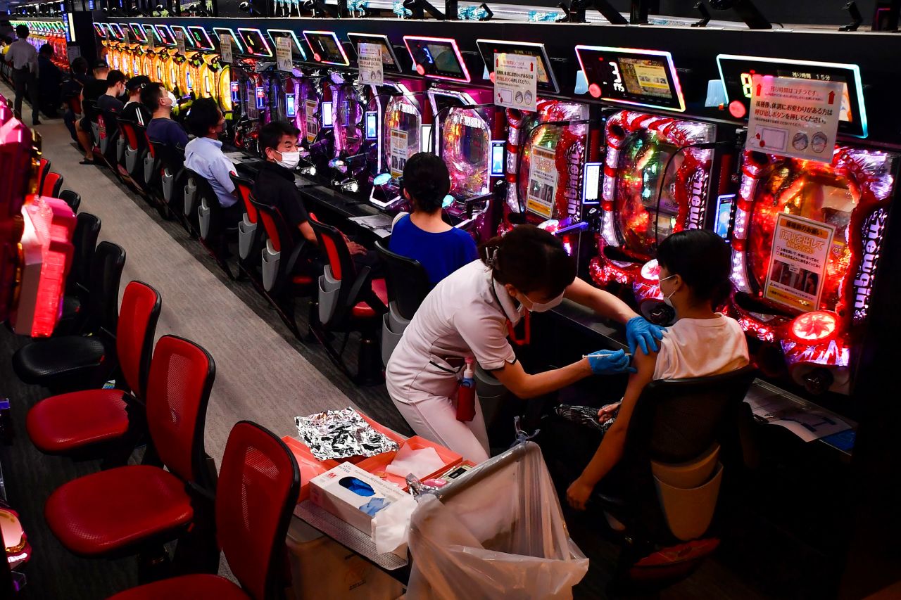 A woman receives a Covid-19 vaccine at a pachinko parlor in Osaka, Japan, on Monday, September 13. The parlor was being used as a makeshift vaccination site.