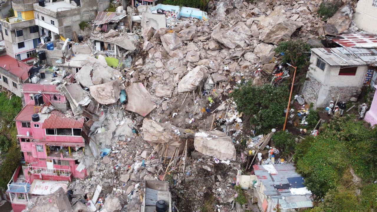 Rescuers work at the site of a landslide in Tlalnepantla, Mexico, on Saturday, September 11. The collapse happened a day earlier and buried three houses.