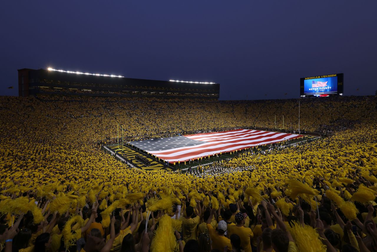 An American flag is unfurled at Michigan Stadium before a college football game in Ann Arbor, Michigan, on Saturday, September 11.