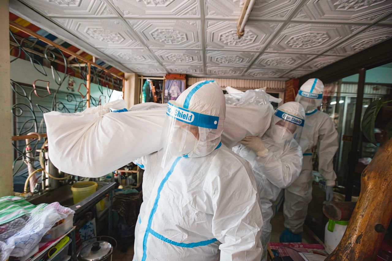 Workers wearing personal protective equipment carry a Covid-19 victim at a house in Nonthaburi, Thailand, on Wednesday, September 15. Although Thailand kept infection numbers low in 2020 thanks to successful containment measures, <a href="https://www.cnn.com/2021/09/16/world/covid-countries-opening-up-cmd-intl/index.html" target="_blank">the country has struggled to keep cases in check this year.</a>