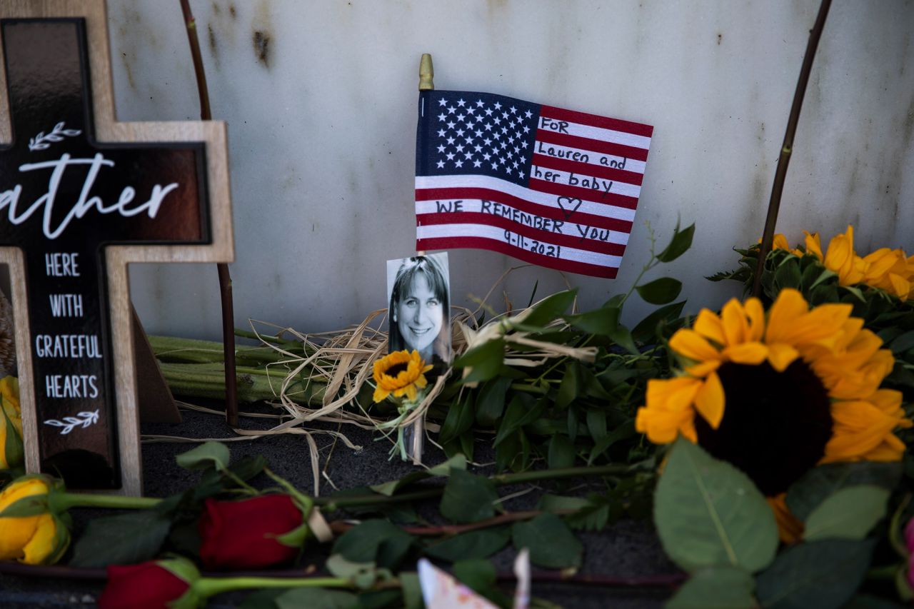 Flowers and flags are left for the victims of United Airlines Flight 93 at a memorial near Shanksville, Pennsylvania, on Saturday, September 11. The hijacked plane crashed into a field 20 years ago.