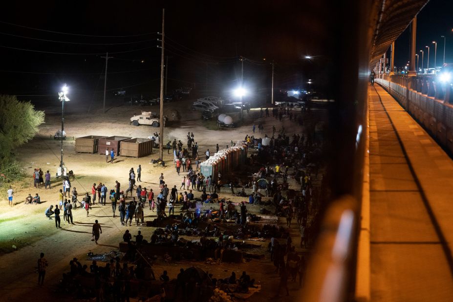 Asylum seekers wait to turn themselves in to Border Patrol agents near the bridge in Del Rio on Thursday, September 16.