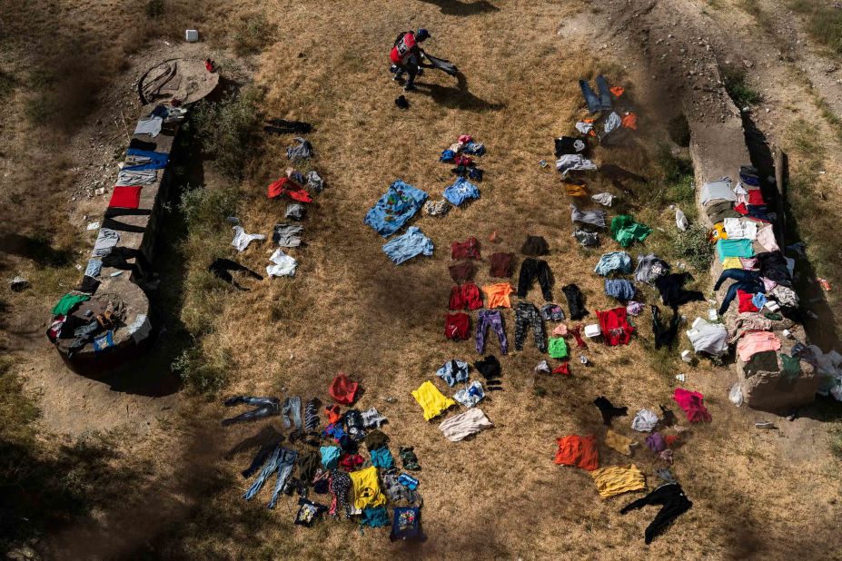 Clothes are laid out on the ground to dry under the International Bridge in Del Rio on Wednesday, September 15.