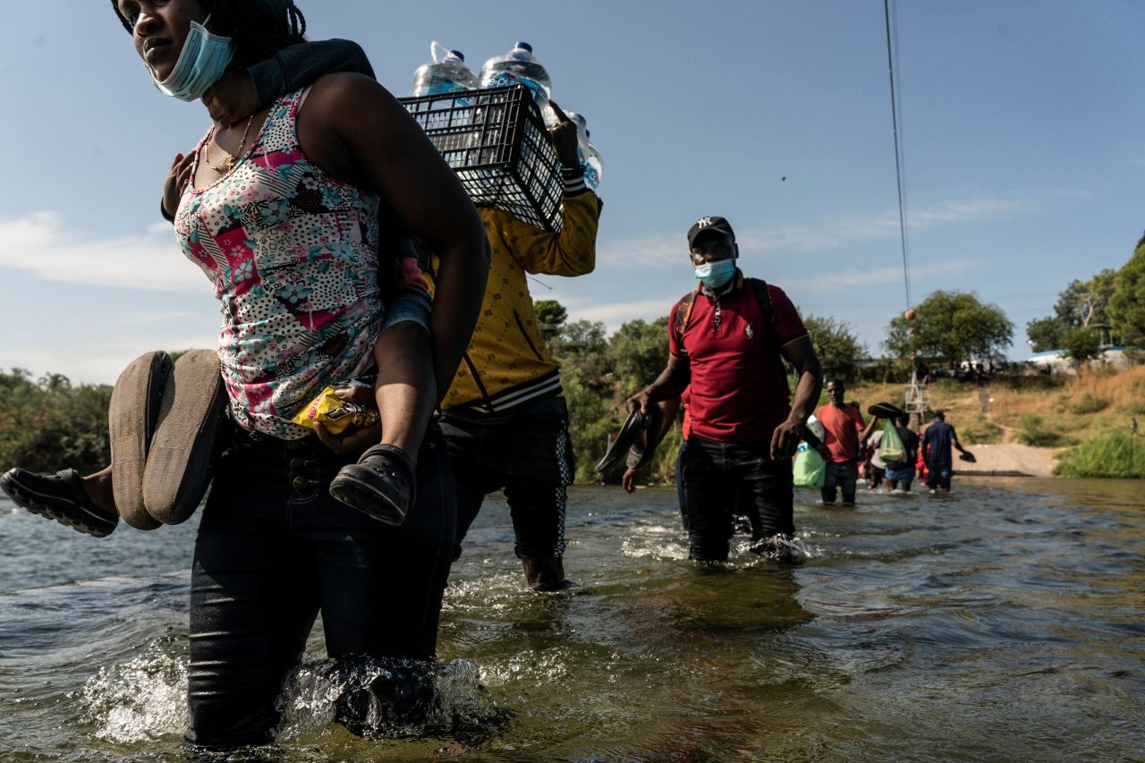 Migrants wade in the Rio Grande on September 16.