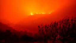 Flames from the KNP Complex Fire burn along a hillside above the Kaweah River in Sequoia National Park, Calif., on Sept. 14, 2021. The blaze is burning near the Giant Forest, home to more than 2,000 giant sequoias. 