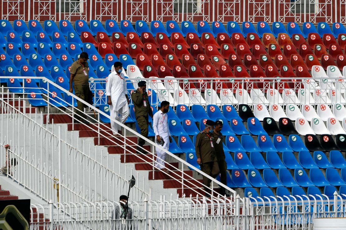 Police walk on the stands of the empty Rawalpindi Cricket Stadium in Rawalpindi on September 17.