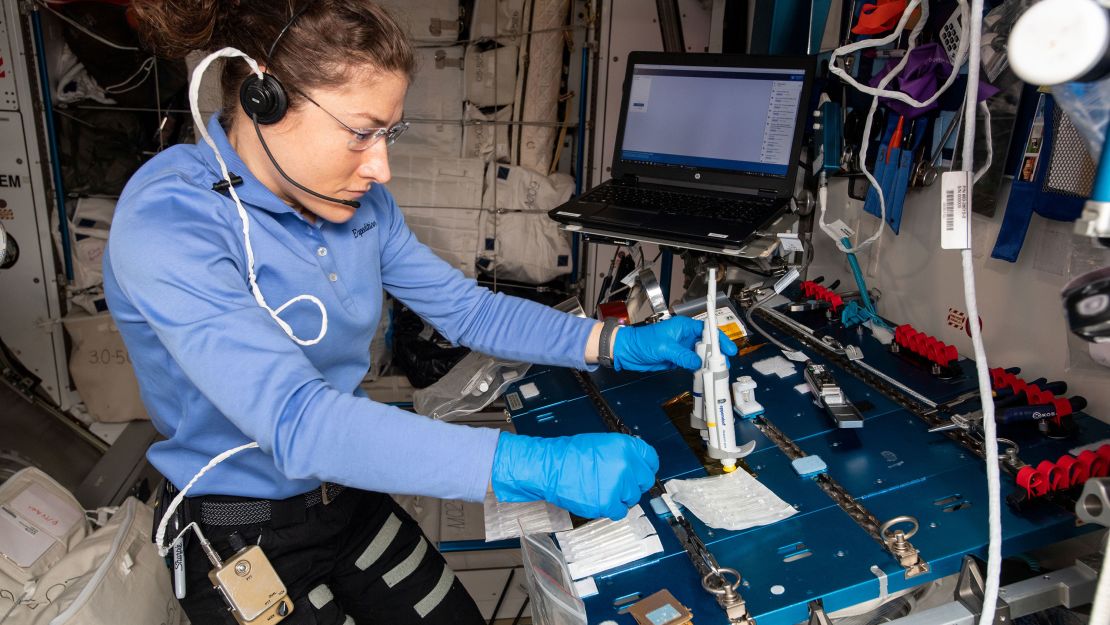 Christina Koch is shown working on the Genes In Space-6 experiment on the space station in 2019.