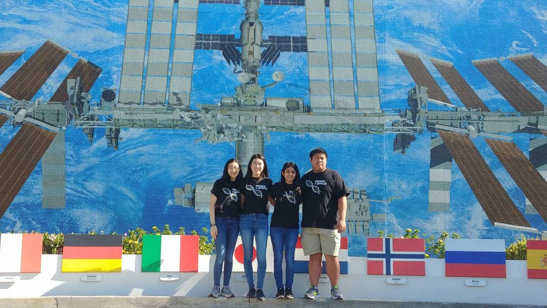 The Genes in Space-6 student team stands in front of an ISS mural. (From left) Rebecca Li, Michelle Sung, Aarthi Vijayakumar and David Li are shown.