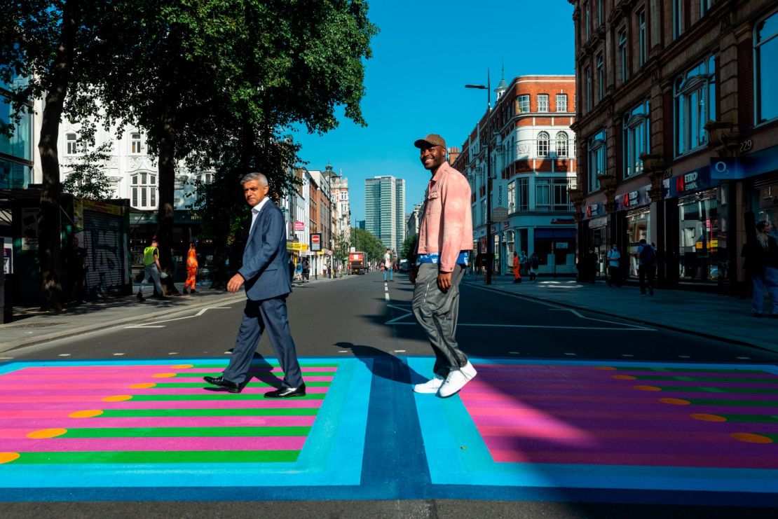 The Mayor of London, Sadiq Khan, and artist Yinka Ilori stride across the new piece of public art.