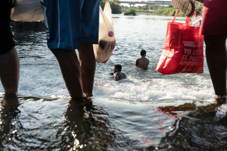 Migrants bathe in the Rio Grande near the Del Rio International Bridge on September 17.