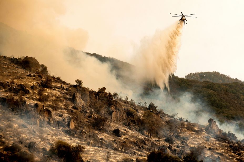 A helicopter drops water on the KNP Complex Fire burning in Sequoia National Park on September 15. 