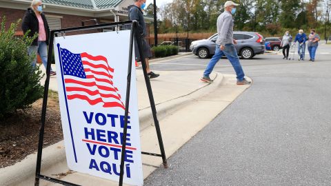 Voters arrive and depart a polling place on October 31, 2020 in Yadkinville, North Carolina.