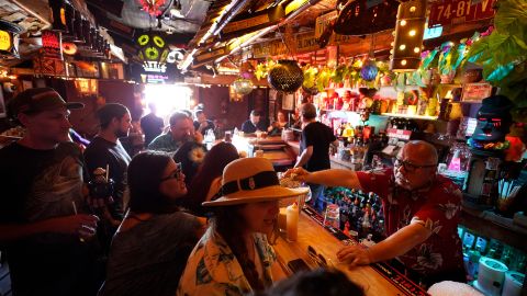In this July 7, 2021, file photo, patrons enjoy cocktails in the tiny interior of the Tiki-Ti bar as it reopens on Sunset Boulevard in Los Angeles