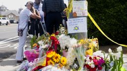 TOPSHOT - Mourners and well wishers leave flowers and signs at a make-shift memorial across the street from the Chabad of Poway Synagogue on Sunday, April 28, 2019 in Poway, California, one day after a teenage gunman opened fire, killing one person and injuring three others including the rabbi as worshippers marked the final day of Passover, authorities said. - The shooting in the town of Poway, north of San Diego, came exactly six months after a white supremacist killed 11 people at Pittsburgh's Tree of Life synagogue -- the deadliest attack on the Jewish community in US history. 