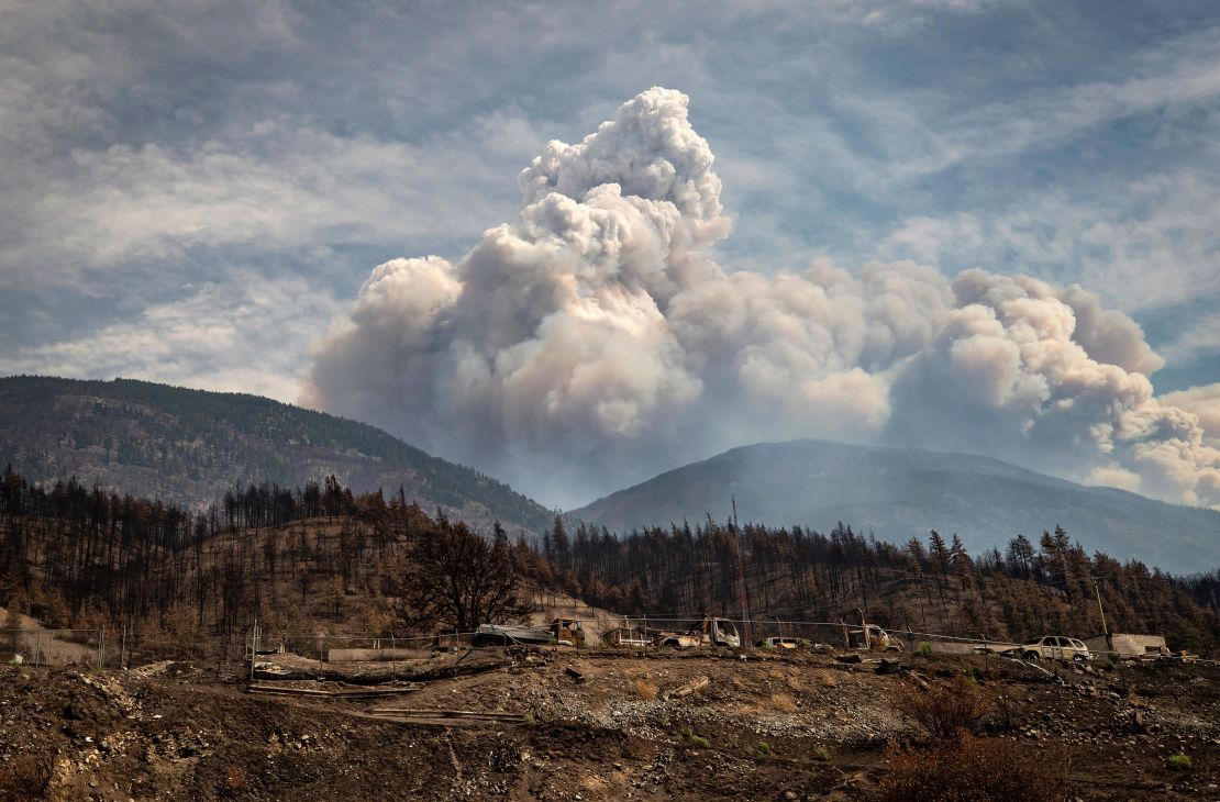 Properties destroyed by the Lytton Creek wildfire on June 30 are seen as a pyrocumulus cloud, also known as a fire cloud, produced by the same fire rises in the mountains above Lytton, British Columbia, on Sunday, Aug. 15, 2021. 