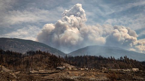 Properties destroyed by the Lytton Creek wildfire on June 30 are seen as a pyrocumulus cloud, also known as a fire cloud, produced by the same fire rises in the mountains above Lytton, British Columbia, on Sunday, Aug. 15, 2021. 