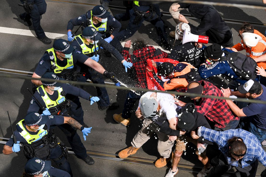 Victoria police fire pepper spray during a clash with protesters at a Rally for Freedom in Melbourne, Australia, on Saturday, Sept. 18, 2021. 